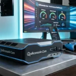 A modern gaming setup featuring a Quikconsole Com gaming console on a wooden desk, with a gaming monitor displaying performance data. A smartphone is also placed next to the console, and a gaming controller is visible on the desk.